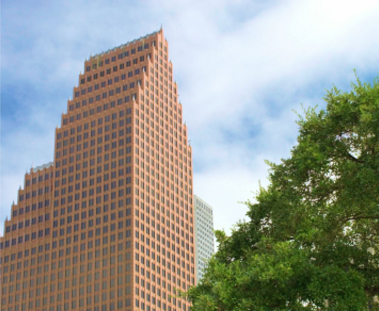 Tall terracotta-colored Houston office tower rising beside leafy trees under a cloudy sky.